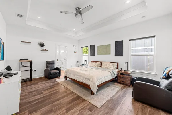 a bedroom with a bed couch and a window