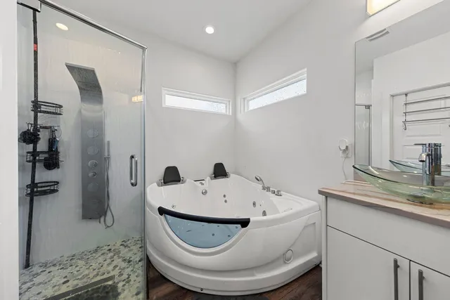 a bathroom with a bathtub and shower