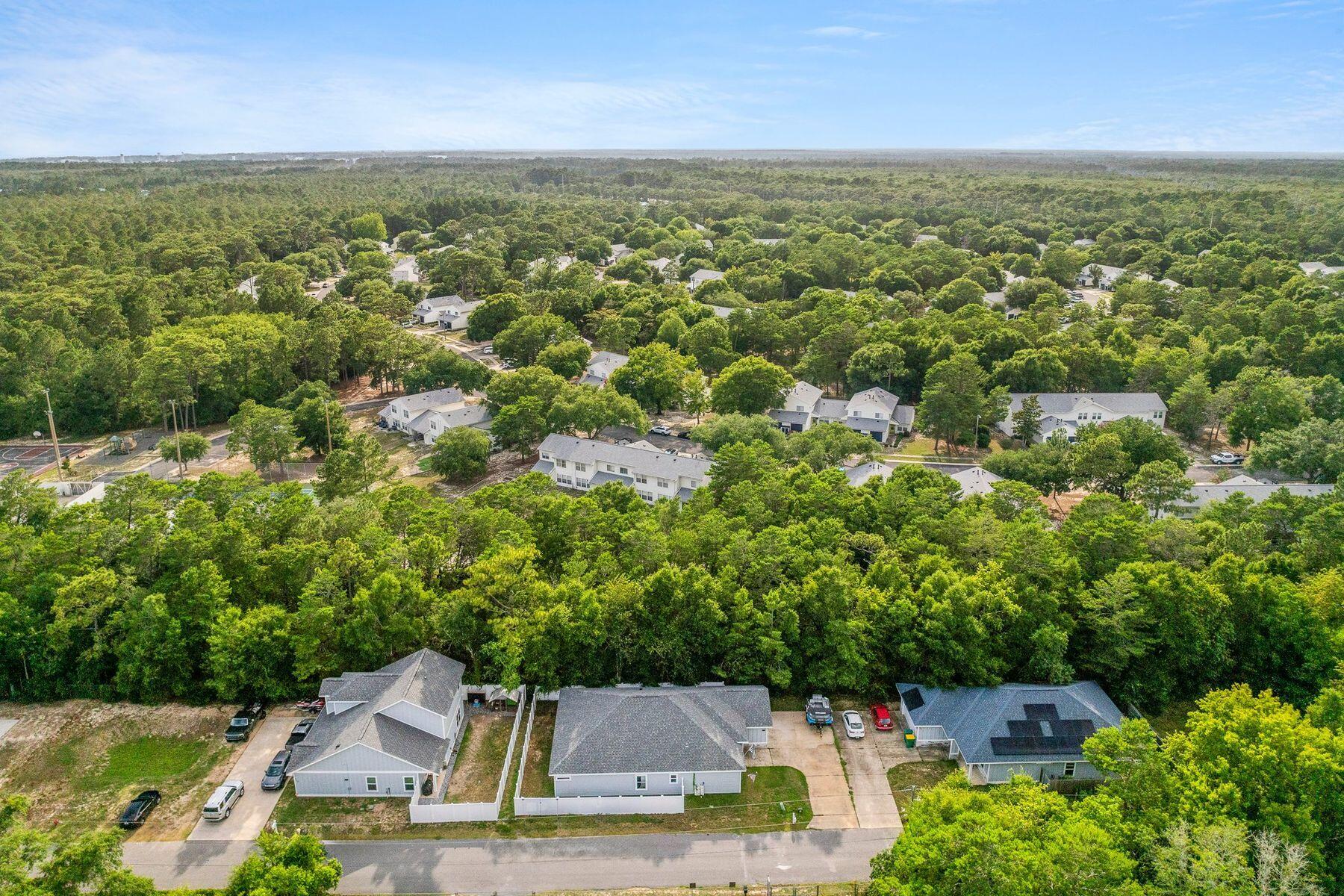736 Comanche Drive Fort Walton Beach, FL 32547 - Photo 40 of 49 an aerial view of residential houses with outdoor space and trees