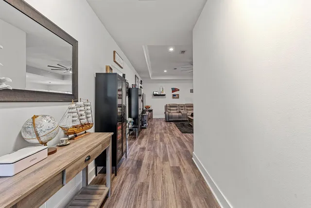 a view of a living room with furniture and wooden floor