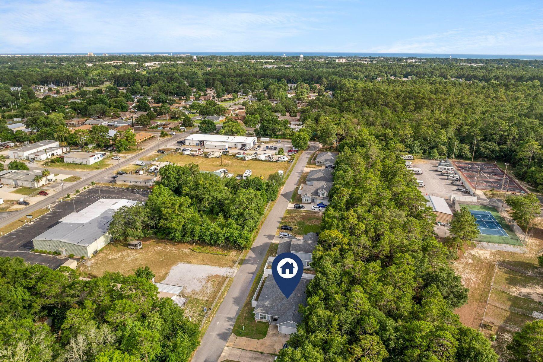 736 Comanche Drive Fort Walton Beach, FL 32547 - Photo 44 of 49 an aerial view of residential houses with outdoor space and trees