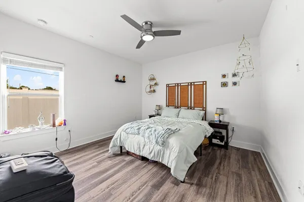 a bedroom with a bed and wooden floor