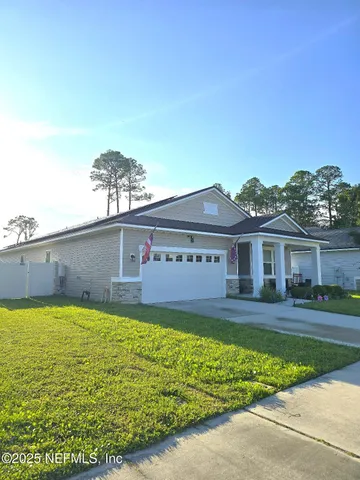 a view of a house with a yard and a garden