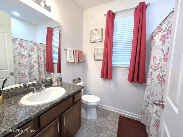 a view of a house with a yard and porch