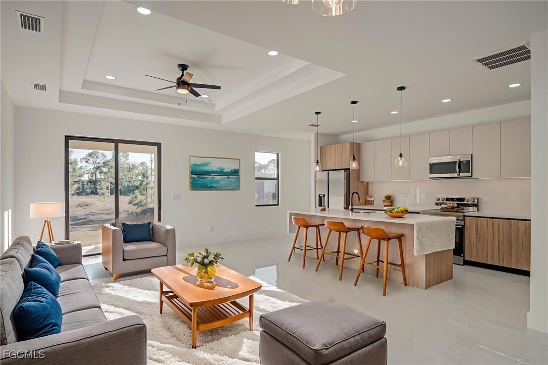 3601 28th Street Southwest Lehigh Acres, FL 33976 - Photo 2 of 35 a living room with furniture kitchen view and a large window