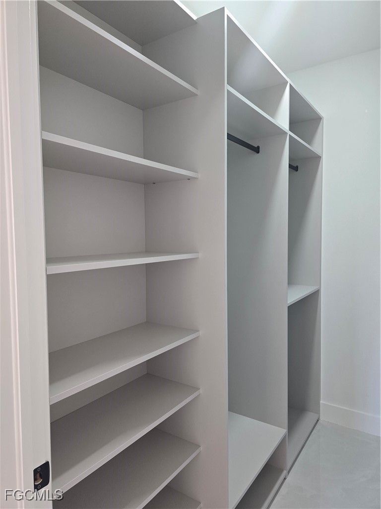 3601 28th Street Southwest Lehigh Acres, FL 33976 - Photo 24 of 35 a view of walk in closet with empty racks