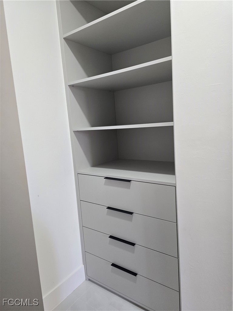 3601 28th Street Southwest Lehigh Acres, FL 33976 - Photo 25 of 35 a view of walk in closet with empty racks