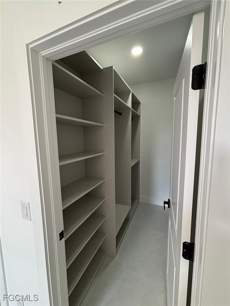 3601 28th Street Southwest Lehigh Acres, FL 33976 - Photo 27 of 35 a view of walk in closet with empty racks