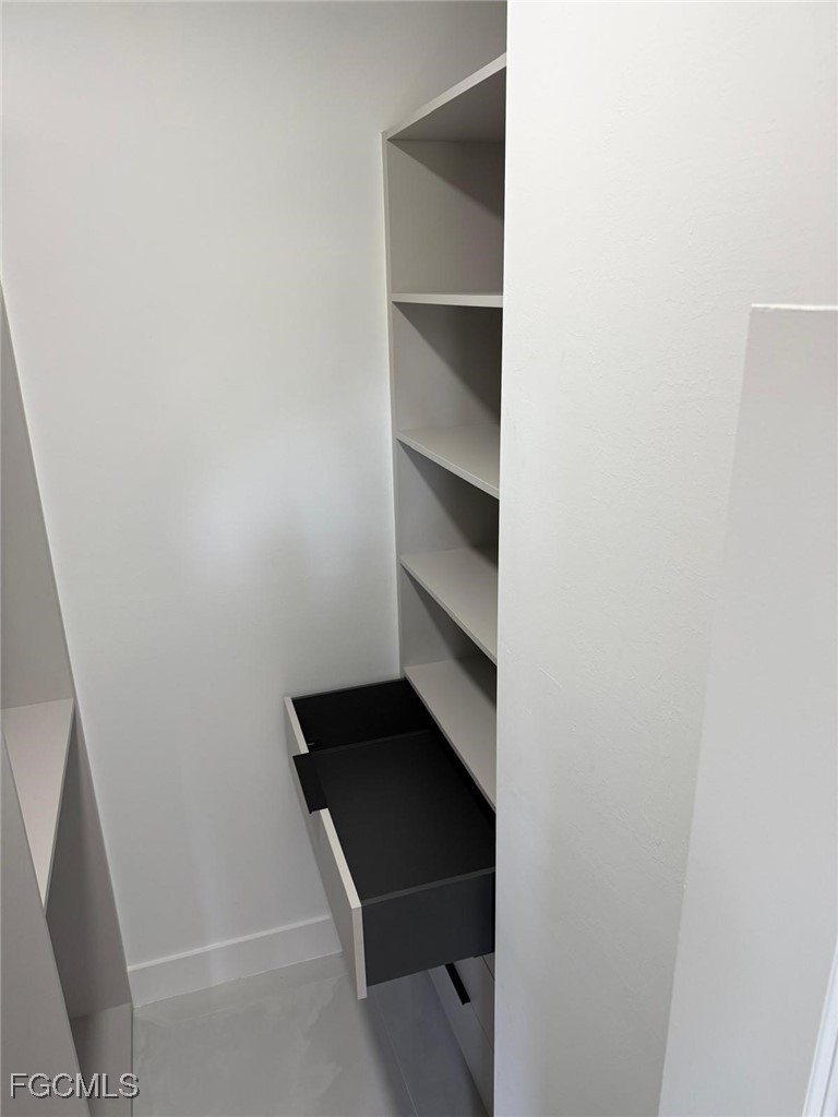 3601 28th Street Southwest Lehigh Acres, FL 33976 - Photo 28 of 35 a view of walk in closet with empty racks