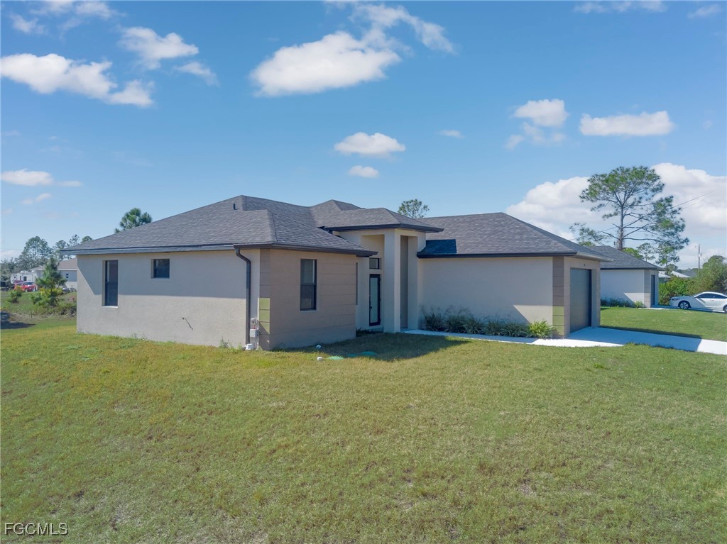 3601 28th Street Southwest Lehigh Acres, FL 33976 - Photo 31 of 35 a front view of a house with a yard and garage
