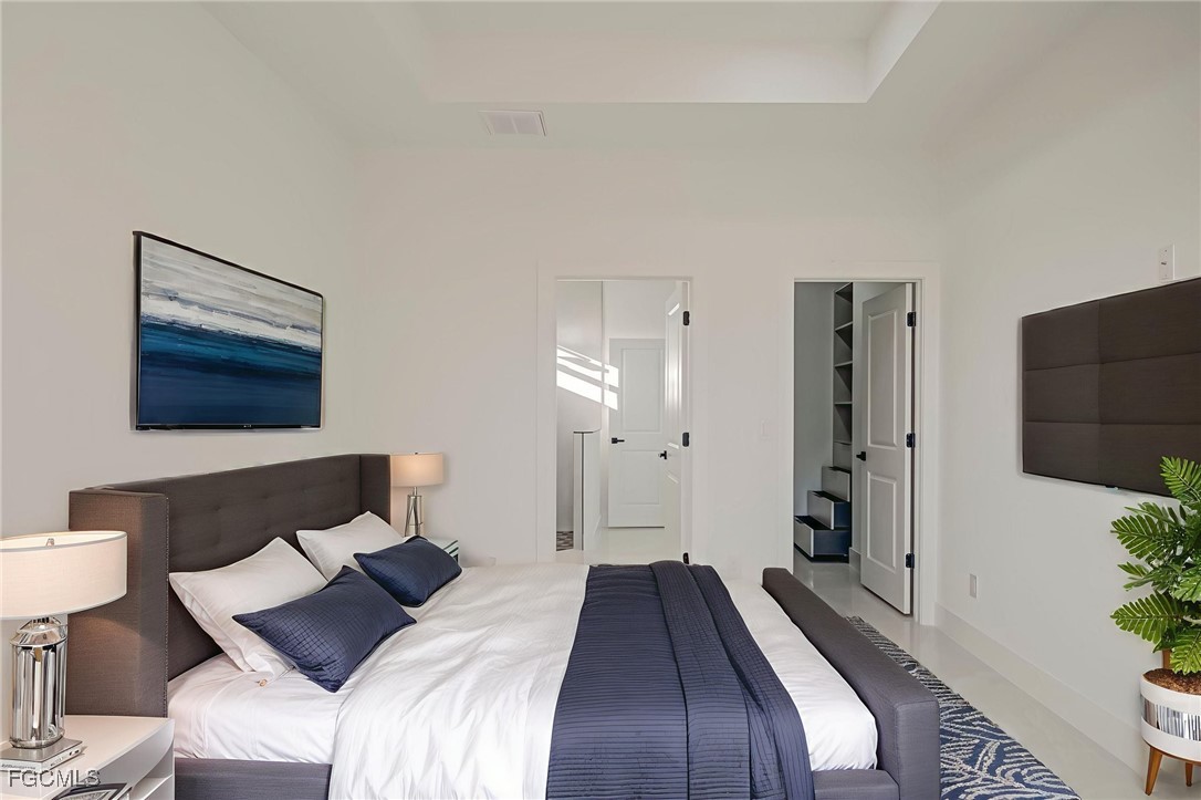 3601 28th Street Southwest Lehigh Acres, FL 33976 - Photo 5 of 35 a bedroom with a bed and a lamp