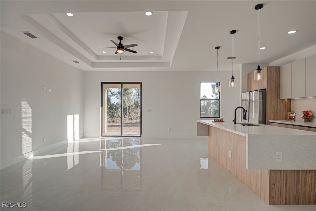 3601 28th Street Southwest Lehigh Acres, FL 33976 - Photo 8 of 35 a view of a kitchen with kitchen island a sink stainless steel appliances and cabinets
