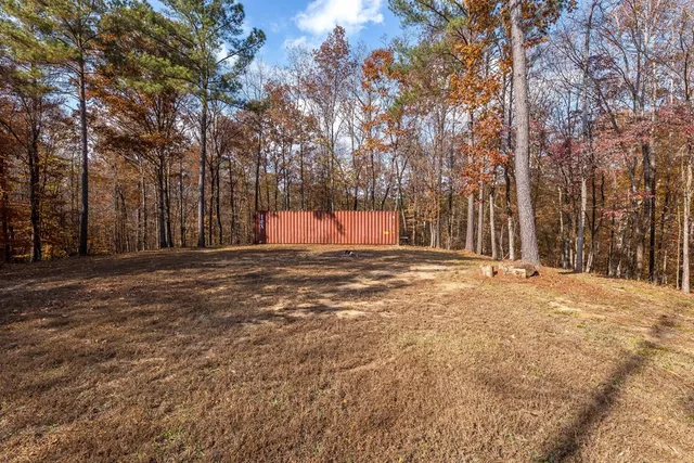 a view of large tree with wooden fence