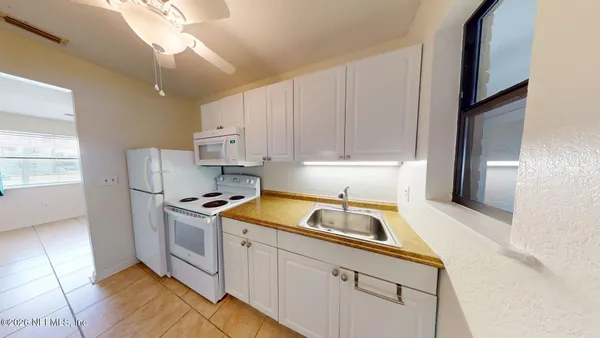 a kitchen that has a sink and a stove top oven