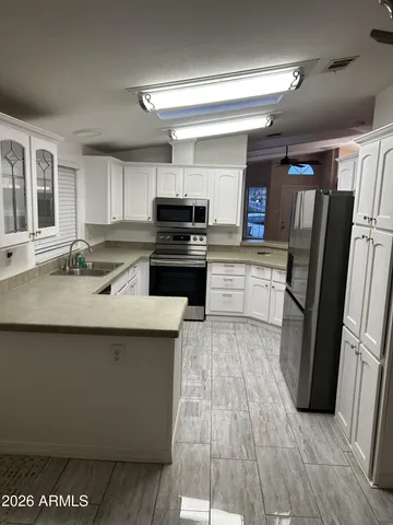 a view of a livingroom with furniture and a ceiling fan