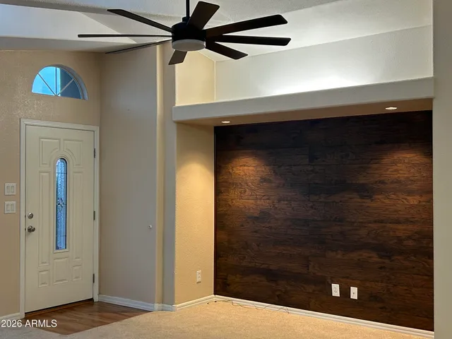 a view of a work space with wooden floor and a window