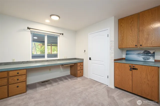a kitchen with cabinets appliances and a window