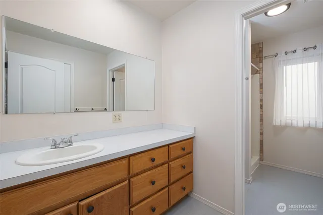 an empty room with a window and a ceiling fan