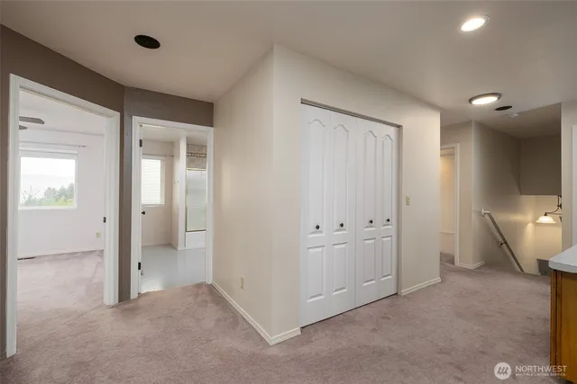 an empty room with fan and windows