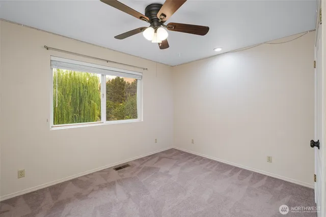 a kitchen with cabinets and a refrigerator