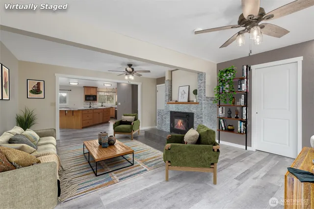 a living room with furniture a fireplace and a window