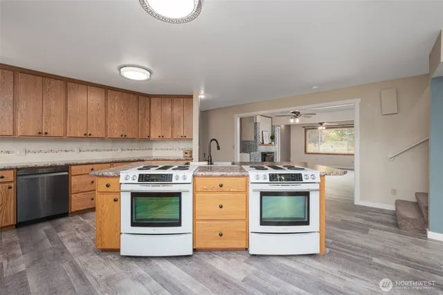 a kitchen with a stove top oven sink and cabinets