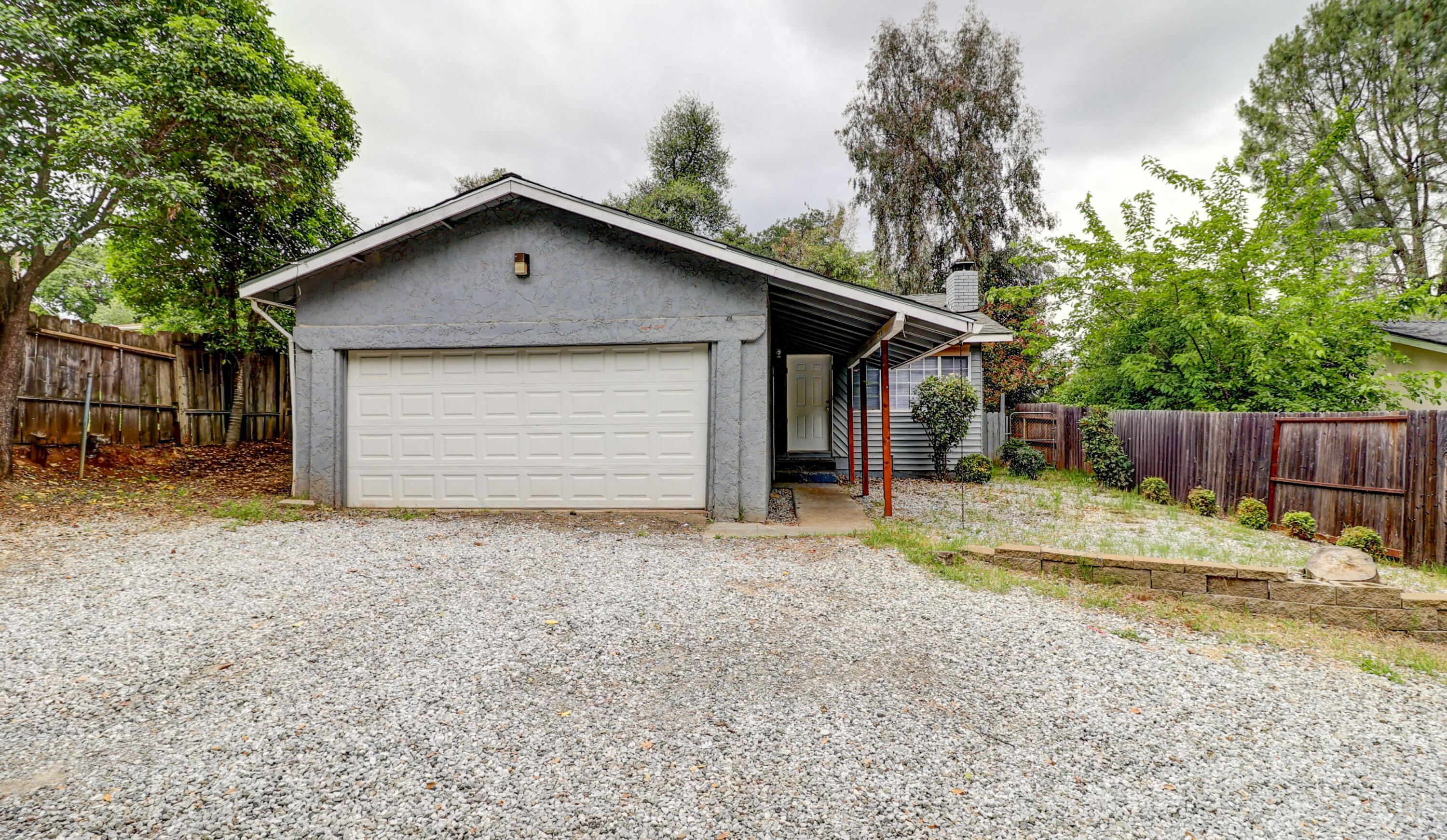 1152-1154 Echo Road Redding, CA 96002 - Photo 5 of 32 a view of backyard of house with wooden fence and trees