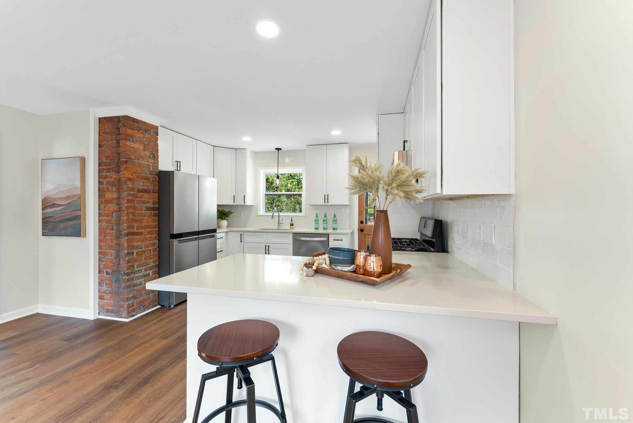 401 Plainview Avenue Raleigh, NC 27604 - Photo 11 of 28 a kitchen with a table chairs and a refrigerator
