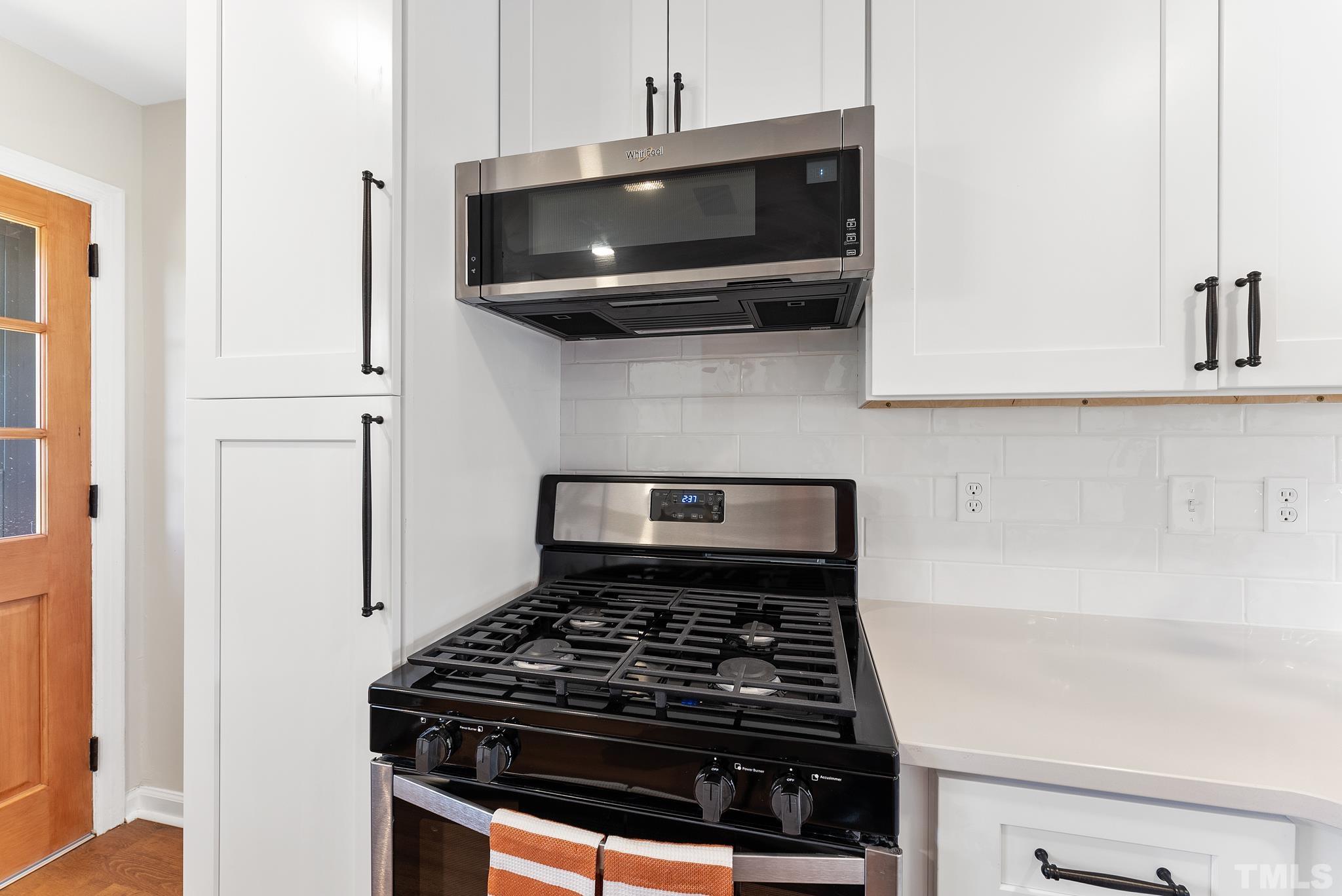 401 Plainview Avenue Raleigh, NC 27604 - Photo 12 of 28 a stove top oven sitting inside of a kitchen