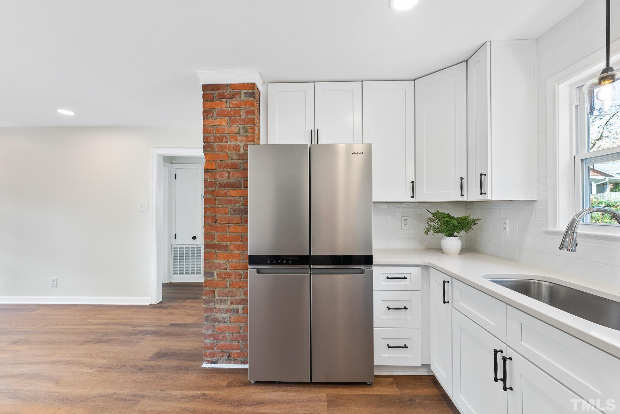 401 Plainview Avenue Raleigh, NC 27604 - Photo 14 of 28 a kitchen with white cabinets and white appliances