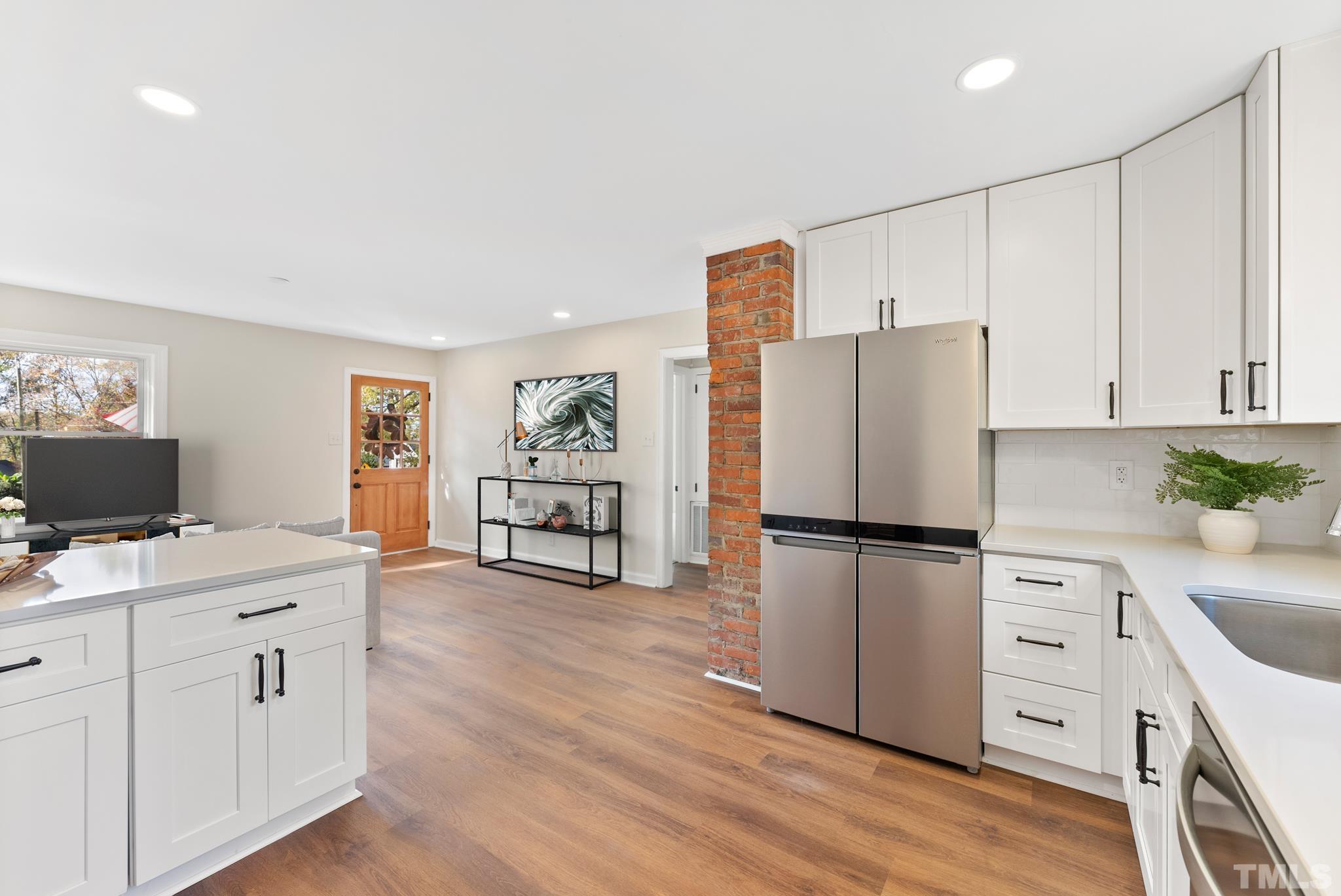 401 Plainview Avenue Raleigh, NC 27604 - Photo 15 of 28 a kitchen with a refrigerator a stove and a wooden floor
