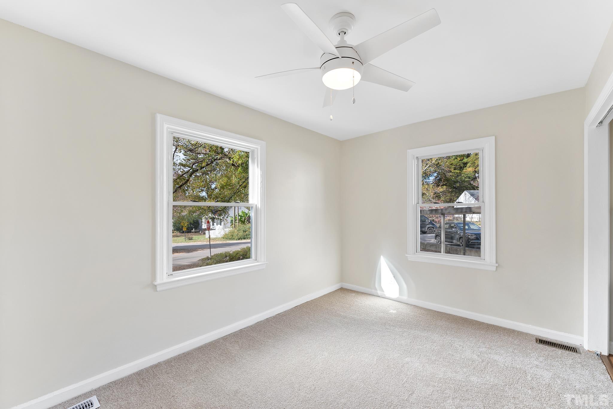 401 Plainview Avenue Raleigh, NC 27604 - Photo 17 of 28 an empty room with windows and fan