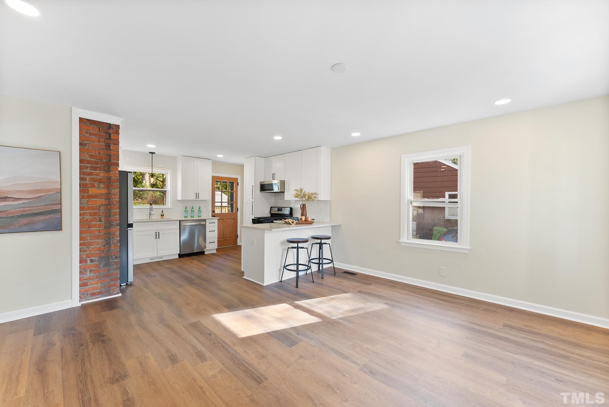 401 Plainview Avenue Raleigh, NC 27604 - Photo 5 of 28 a view of a kitchen with a sink cabinets and wooden floor
