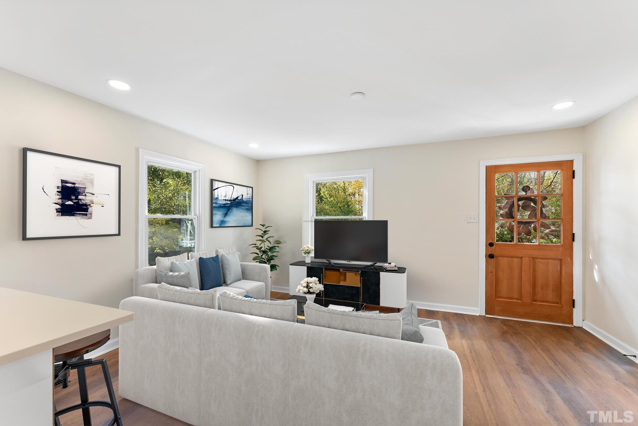 401 Plainview Avenue Raleigh, NC 27604 - Photo 8 of 28 a living room with furniture and a flat screen tv