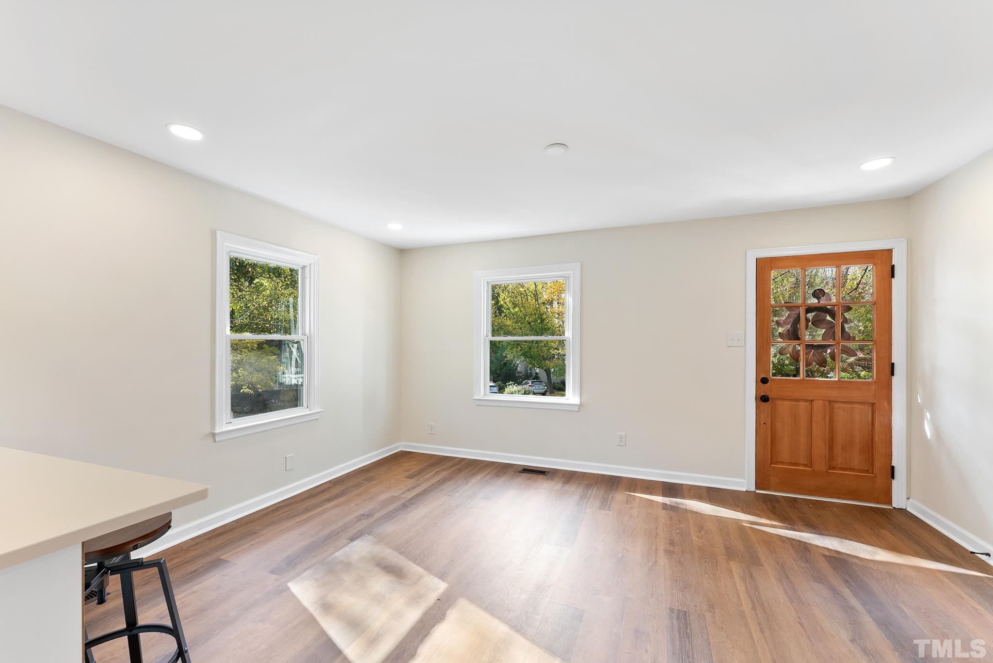 401 Plainview Avenue Raleigh, NC 27604 - Photo 9 of 28 a view of an empty room with a window and wooden floor