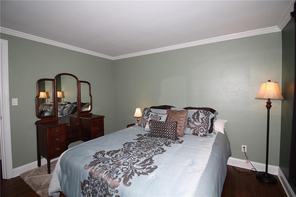 Undisclosed Address Cecil, PA 15321 - Photo 11 of 29 a bedroom with a bed and a lamp on table