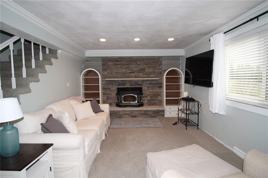 Undisclosed Address Cecil, PA 15321 - Photo 16 of 29 a living room with furniture a flat screen tv and a fireplace