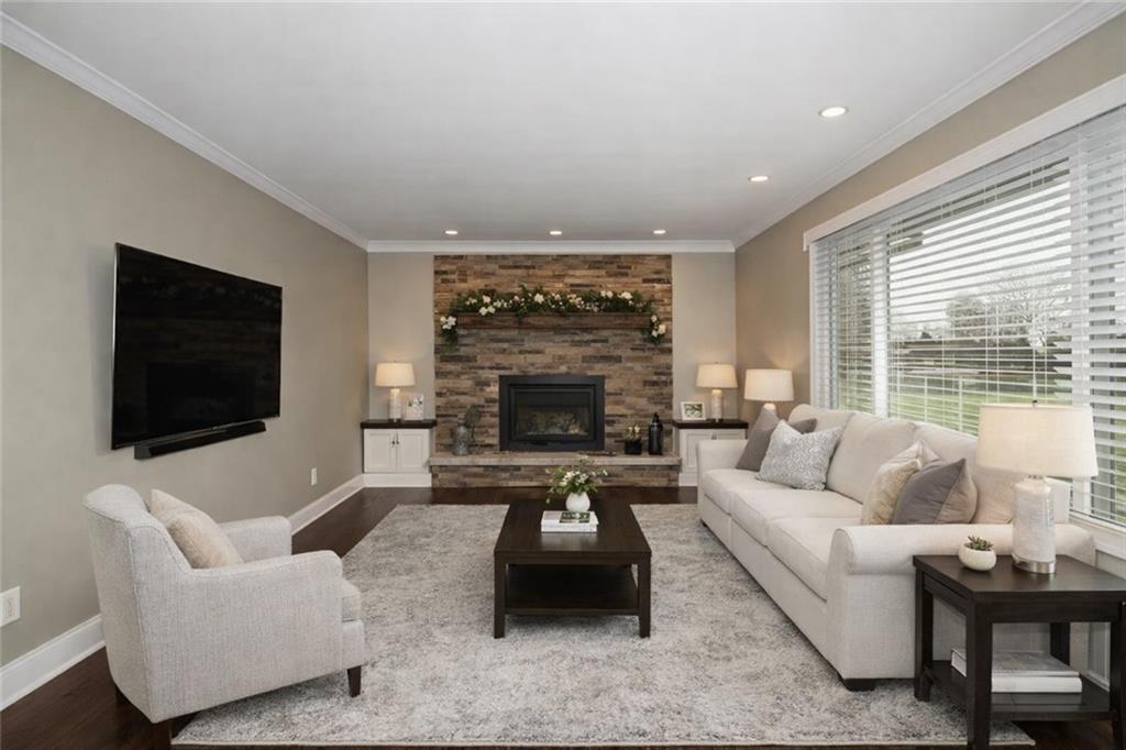 Undisclosed Address Cecil, PA 15321 - Photo 2 of 29 a living room with furniture a flat screen tv and a fireplace