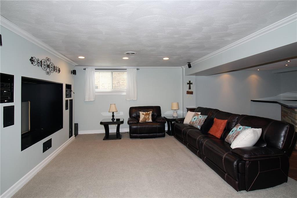 Undisclosed Address Cecil, PA 15321 - Photo 22 of 29 a living room with furniture and a flat screen tv