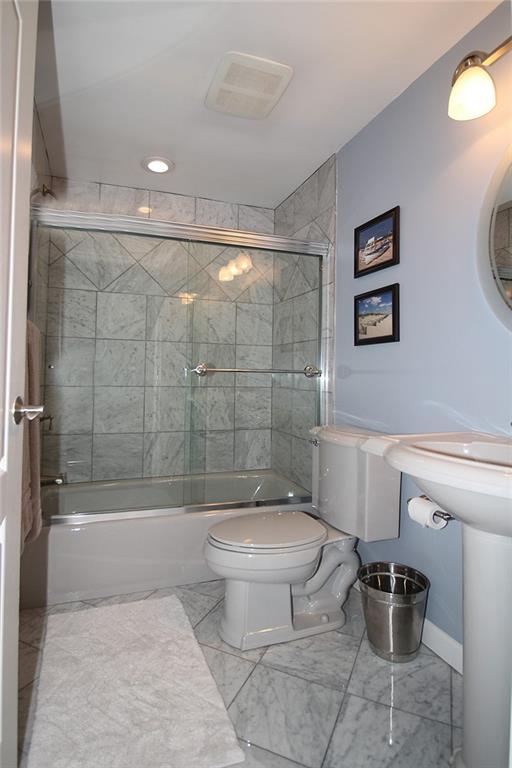 Undisclosed Address Cecil, PA 15321 - Photo 10 of 29 a bathroom with a toilet a sink and bathtub