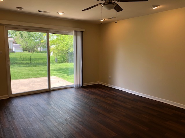624 Quail Run Road Matteson, IL 60443 - Photo 18 of 30 a view of an empty room with wooden floor and a window