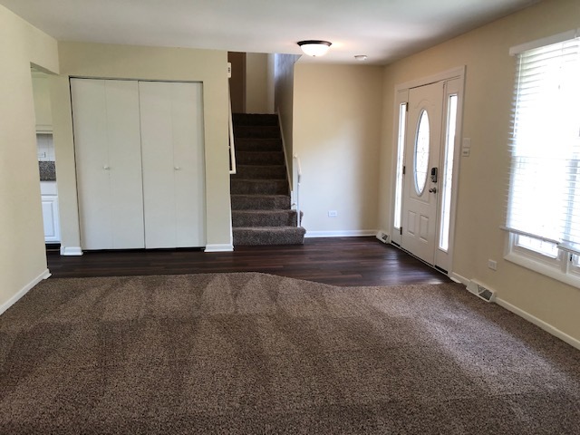 624 Quail Run Road Matteson, IL 60443 - Photo 5 of 30 a view of an empty room with wooden floor and a window