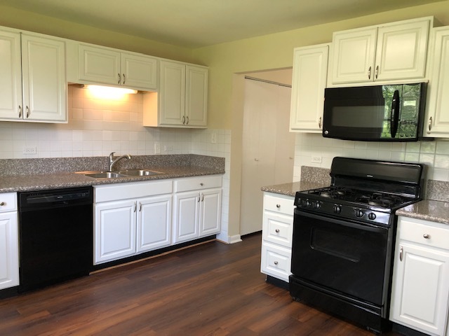 624 Quail Run Road Matteson, IL 60443 - Photo 9 of 30 a kitchen with granite countertop a stove a sink and a microwave