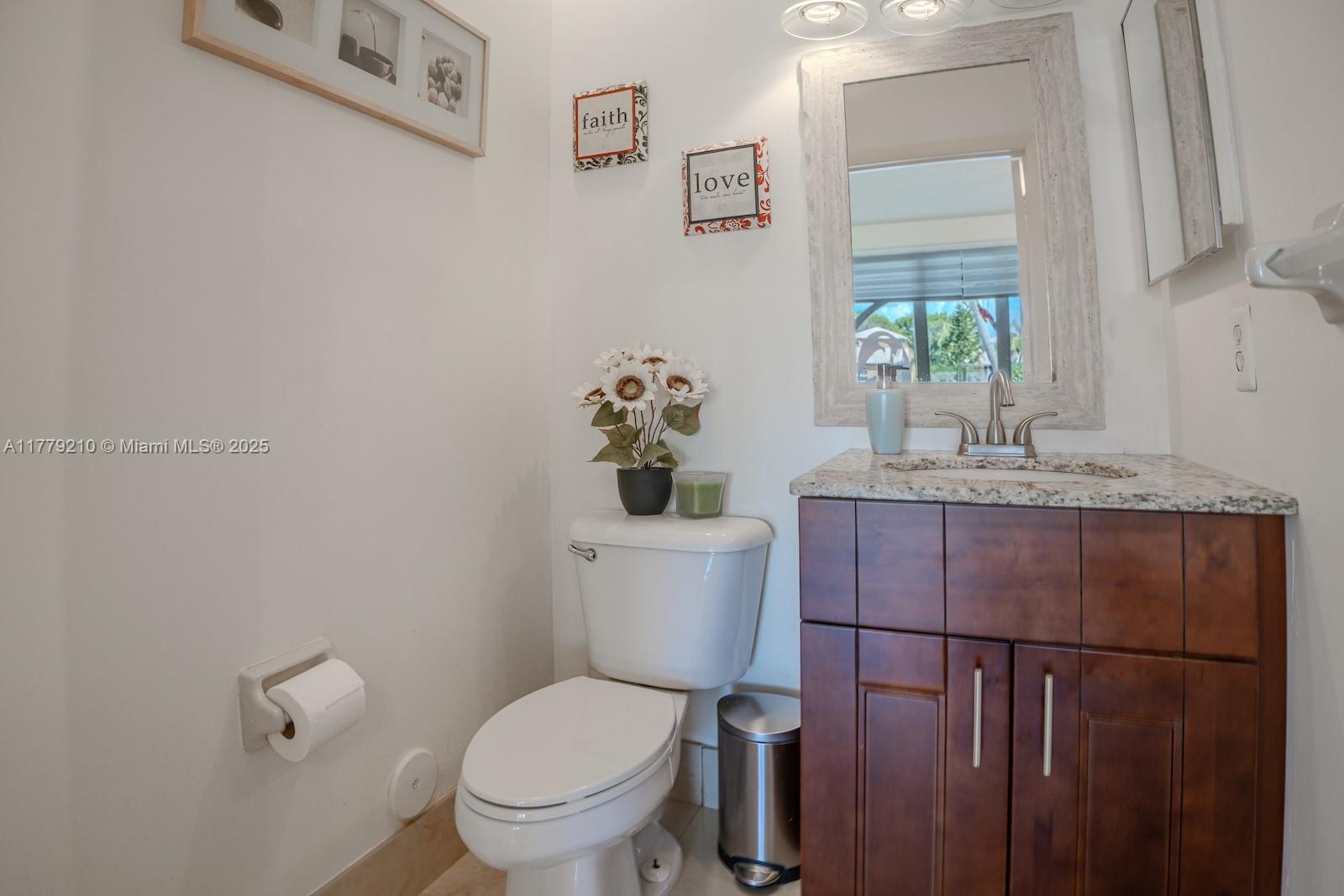 Towngate Pembroke Pines, FL 33028 - Photo 14 of 41 a bathroom with a granite countertop toilet sink and mirror