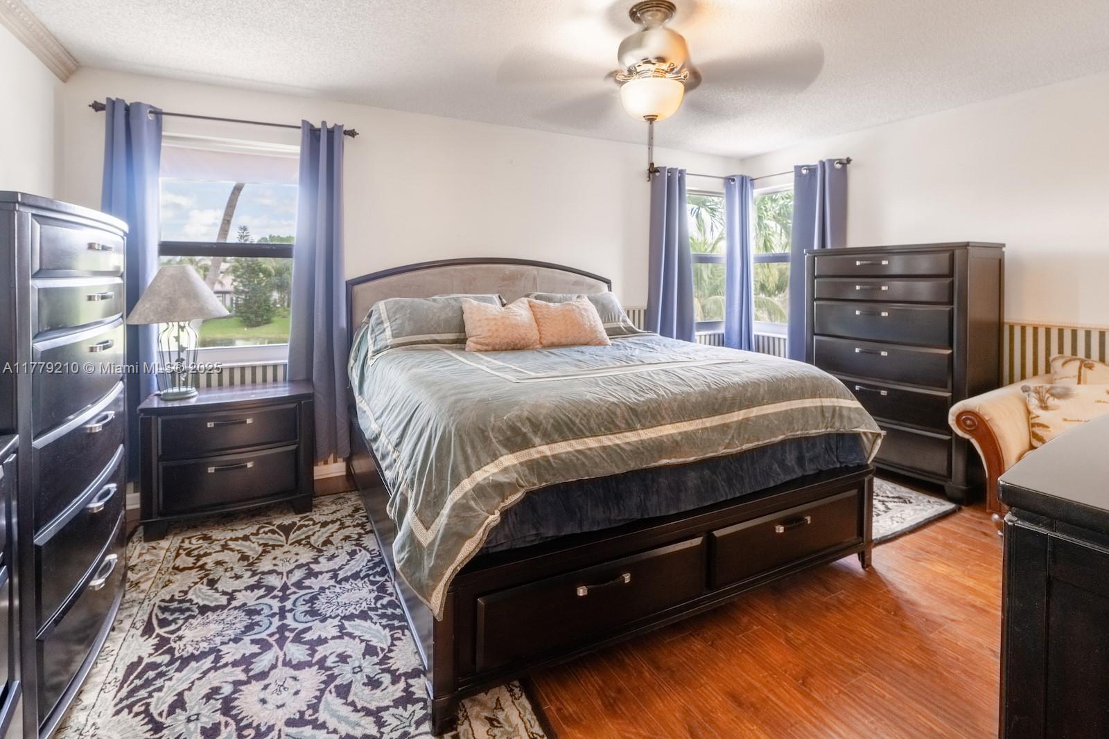 Towngate Pembroke Pines, FL 33028 - Photo 16 of 41 a bedroom with a bed and wooden floor