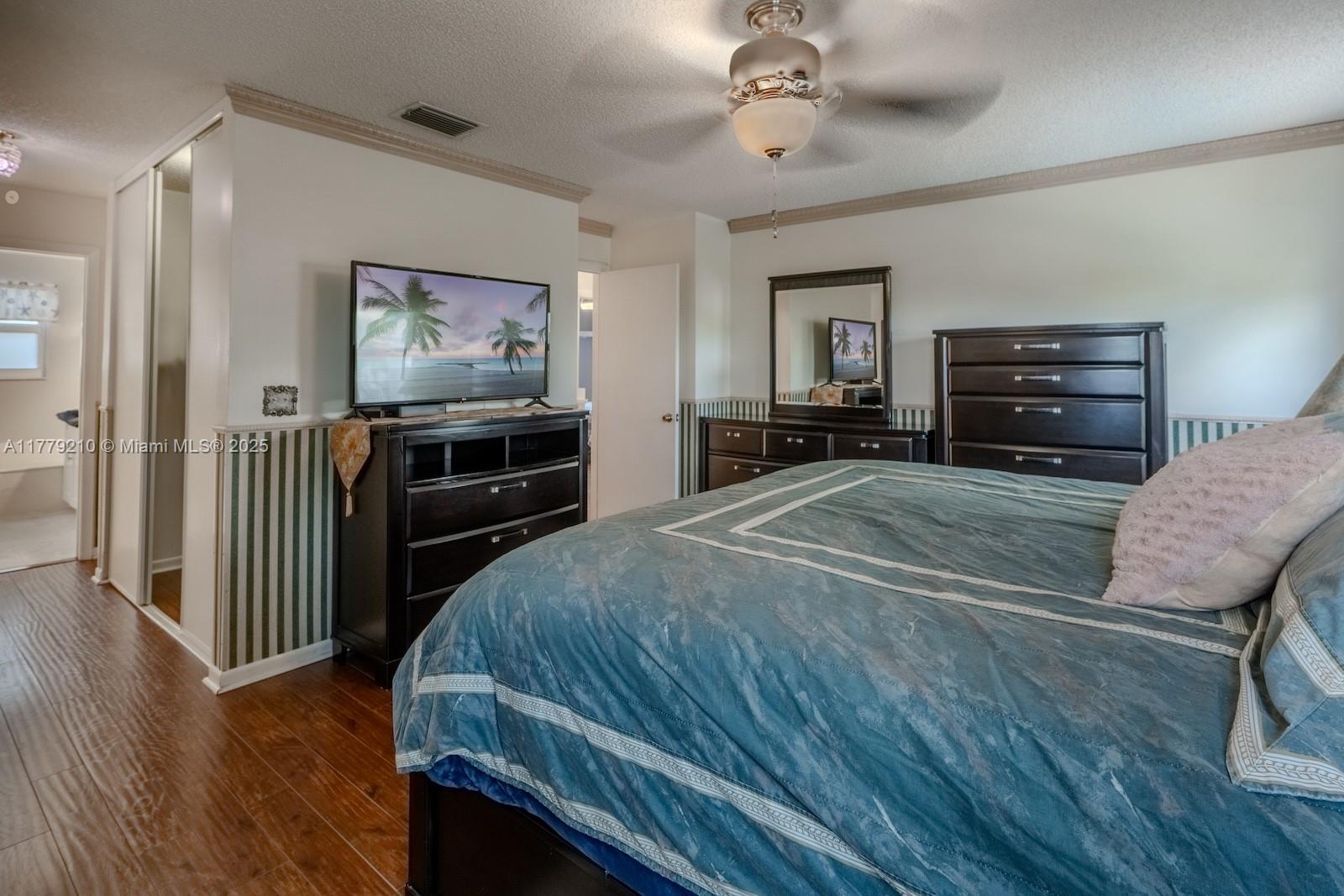 Towngate Pembroke Pines, FL 33028 - Photo 17 of 41 a bedroom with a bed and a flat screen tv