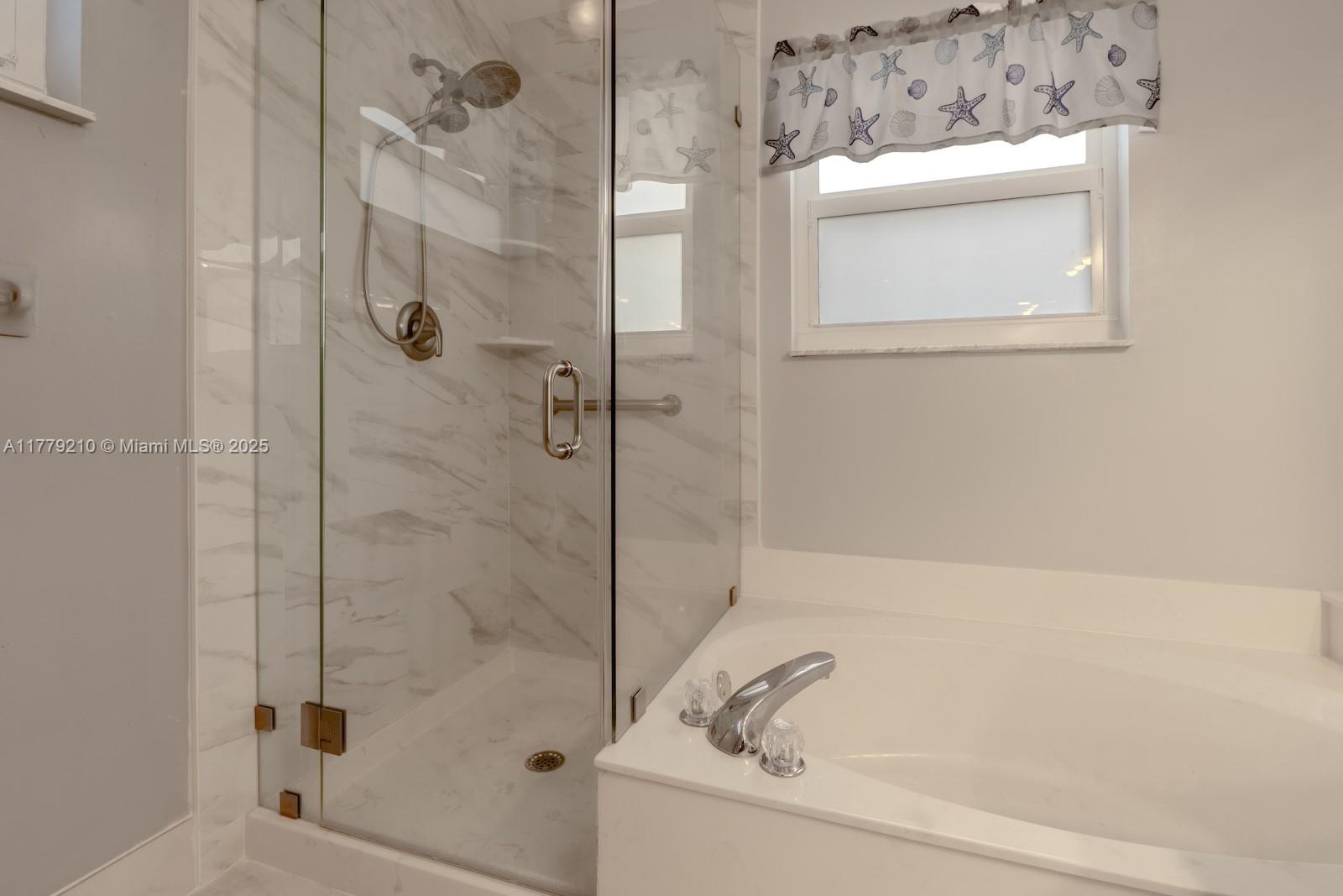 Towngate Pembroke Pines, FL 33028 - Photo 19 of 41 a bathroom with a bathtub and a shower