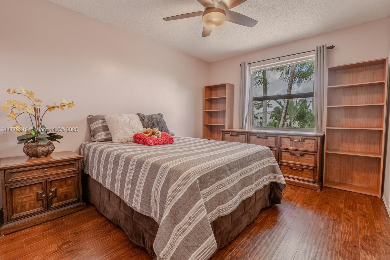Towngate Pembroke Pines, FL 33028 - Photo 21 of 41 a bedroom with a bed and a window