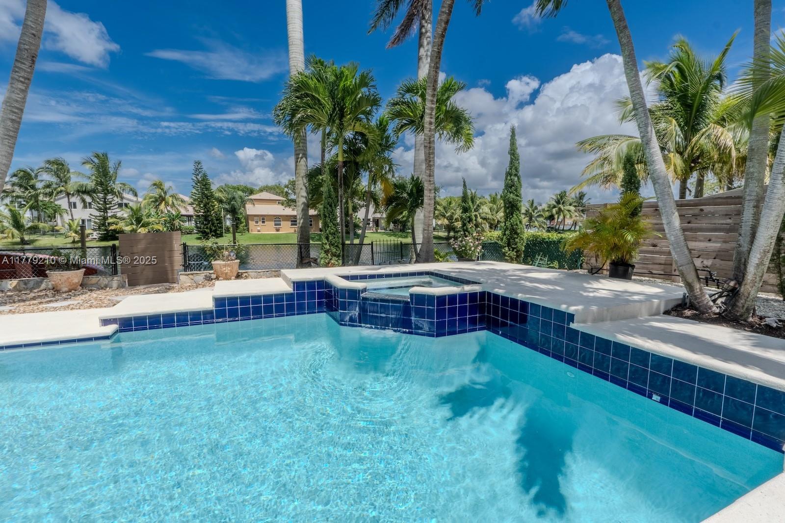 Towngate Pembroke Pines, FL 33028 - Photo 31 of 41 a view of yard with swimming pool and trees in the background
