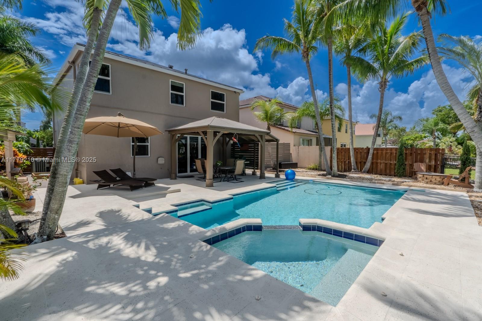 Towngate Pembroke Pines, FL 33028 - Photo 33 of 41 a view of a white house with a yard table and chairs